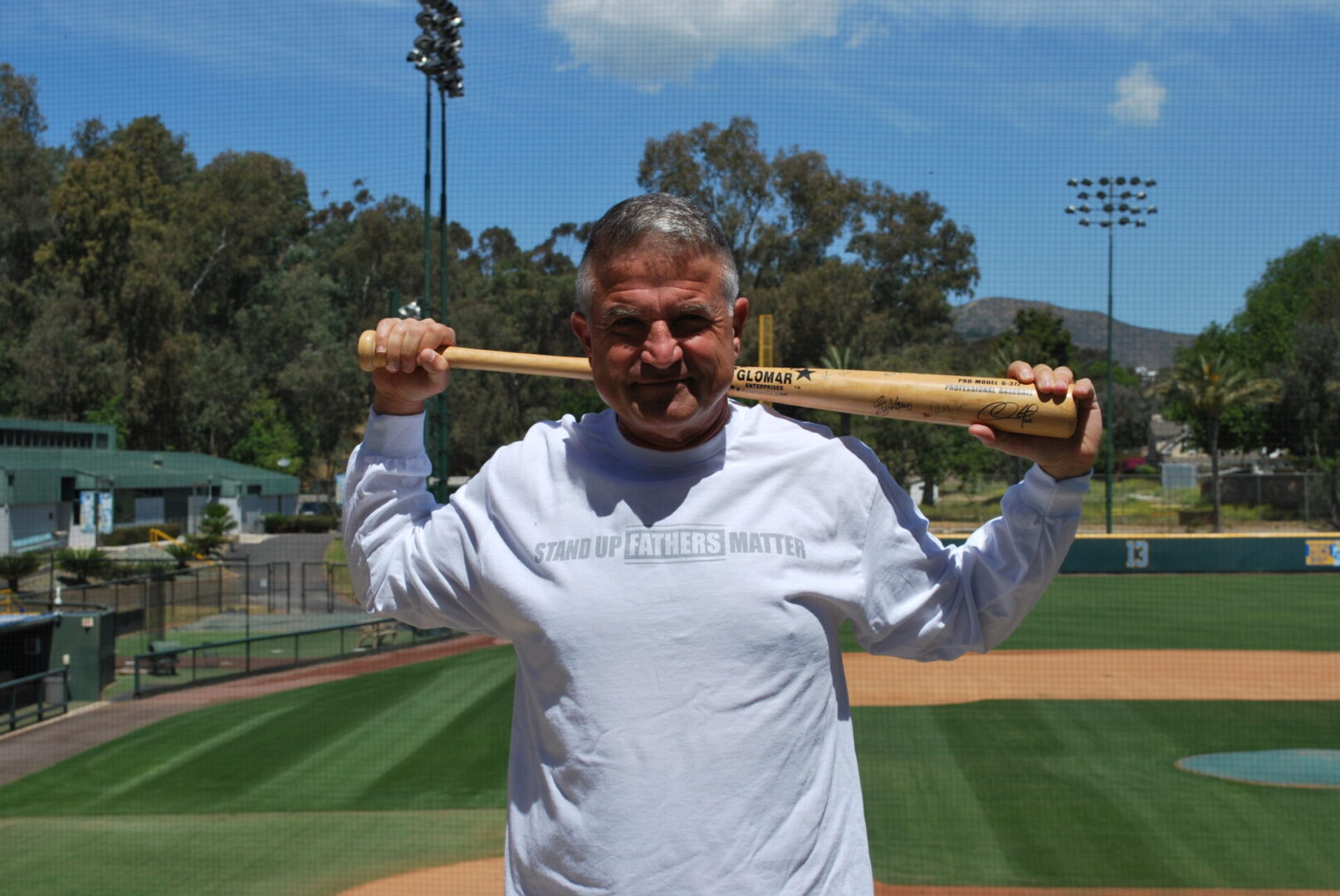 A man holding a baseball bat over his head.